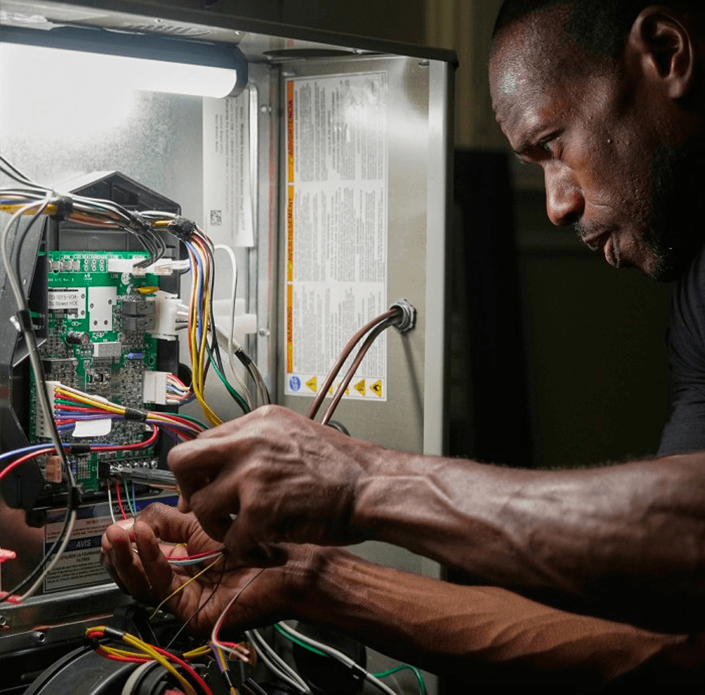 Trane specialist repairing an air conditioner