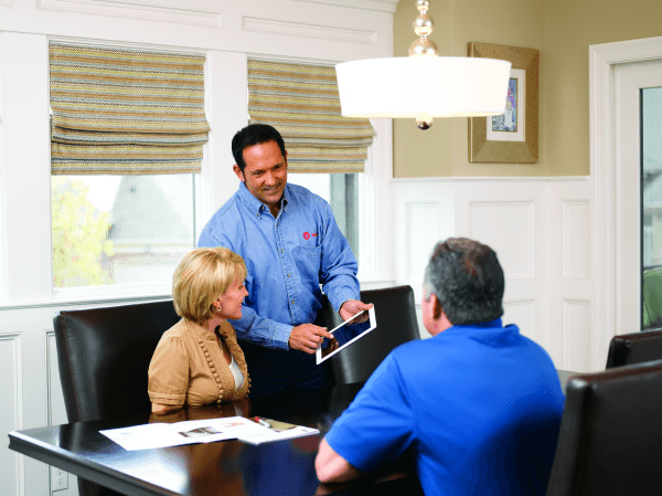 Man and woman talking to HVAC dealer
