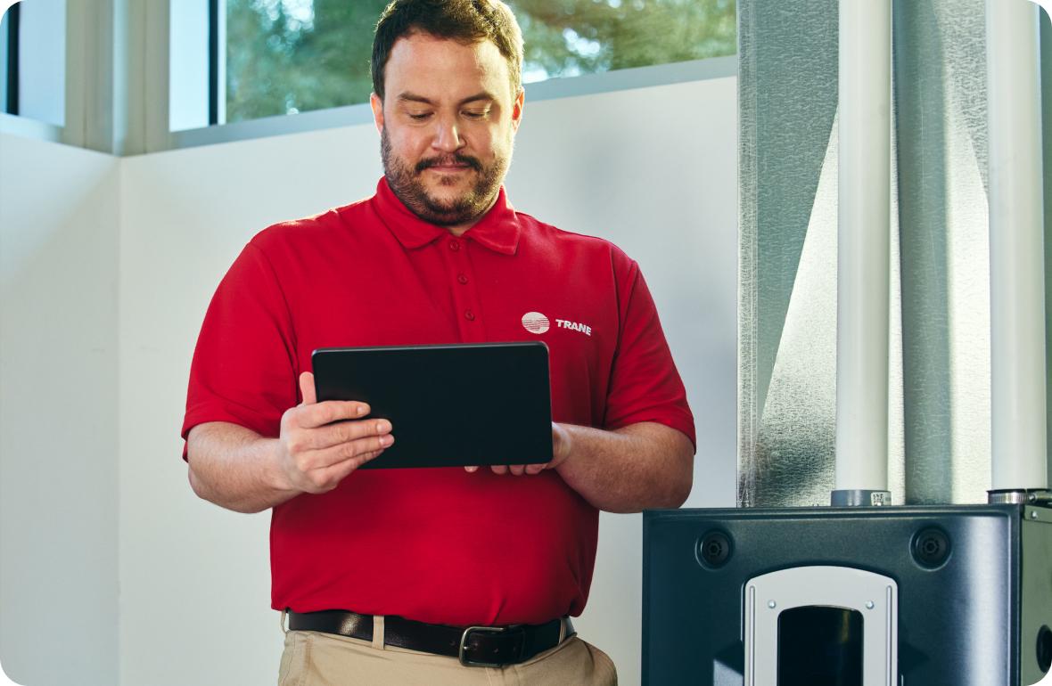 Trane distributor representative monitoring the performance of a Trane HVAC system.
