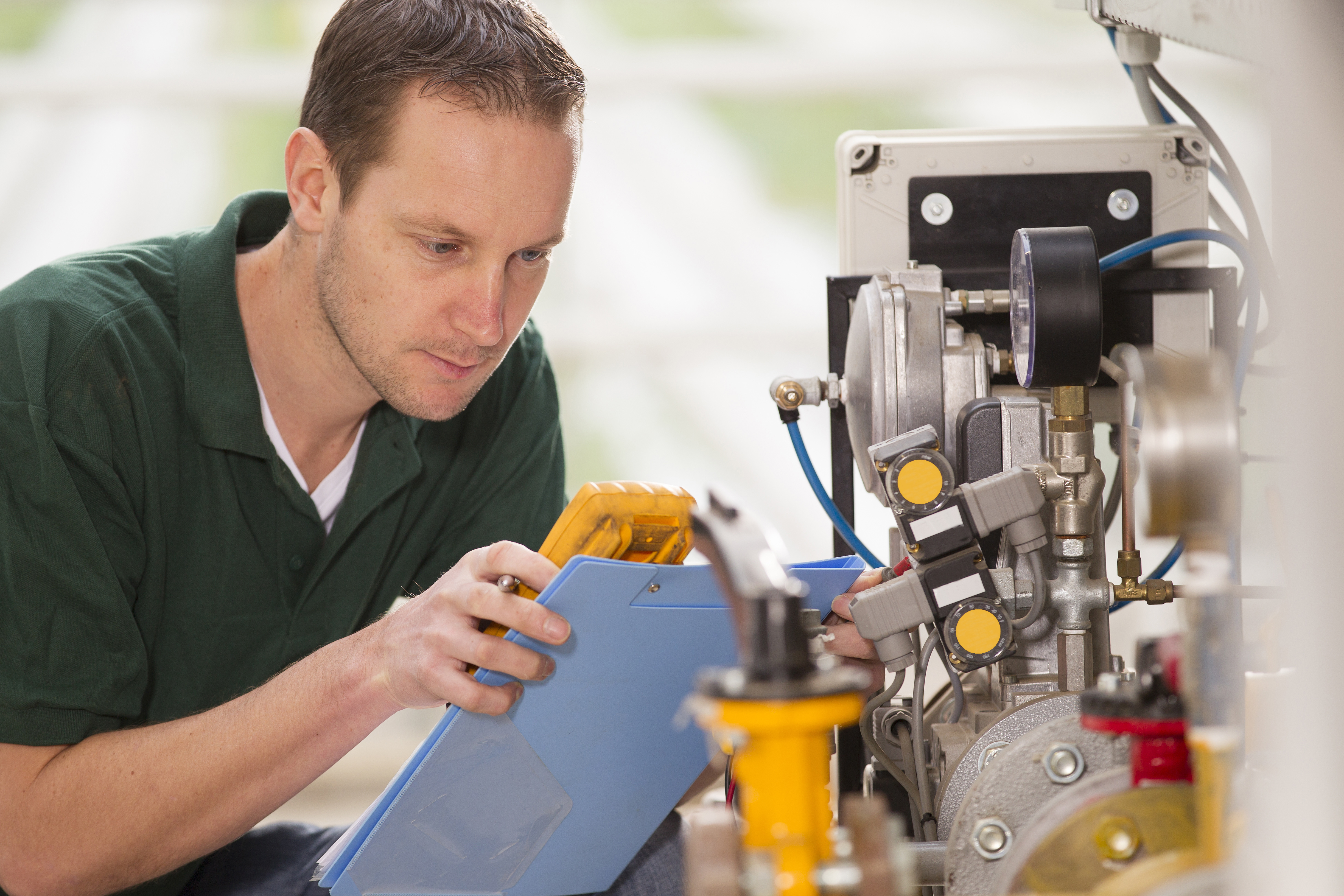 Male technician repairing agriculture machinery