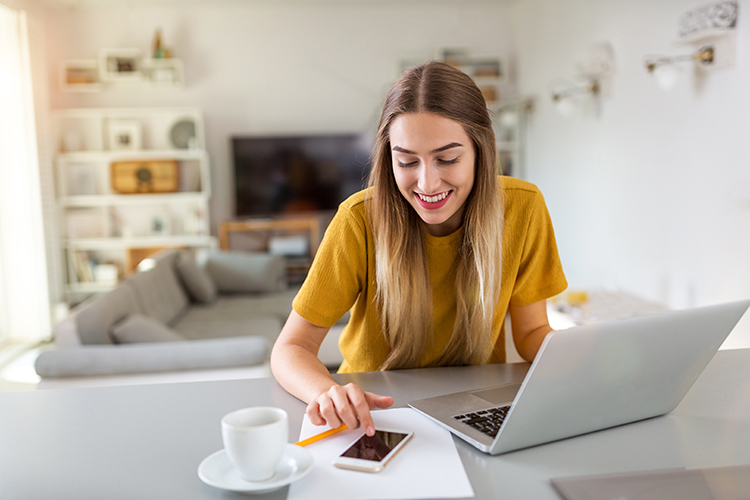 Young woman using her laptop at home 